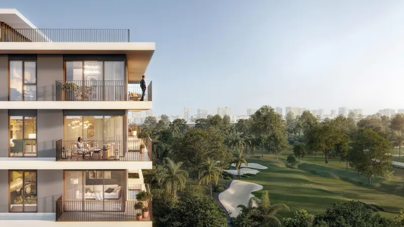 a building with a balcony and a golf course in the background