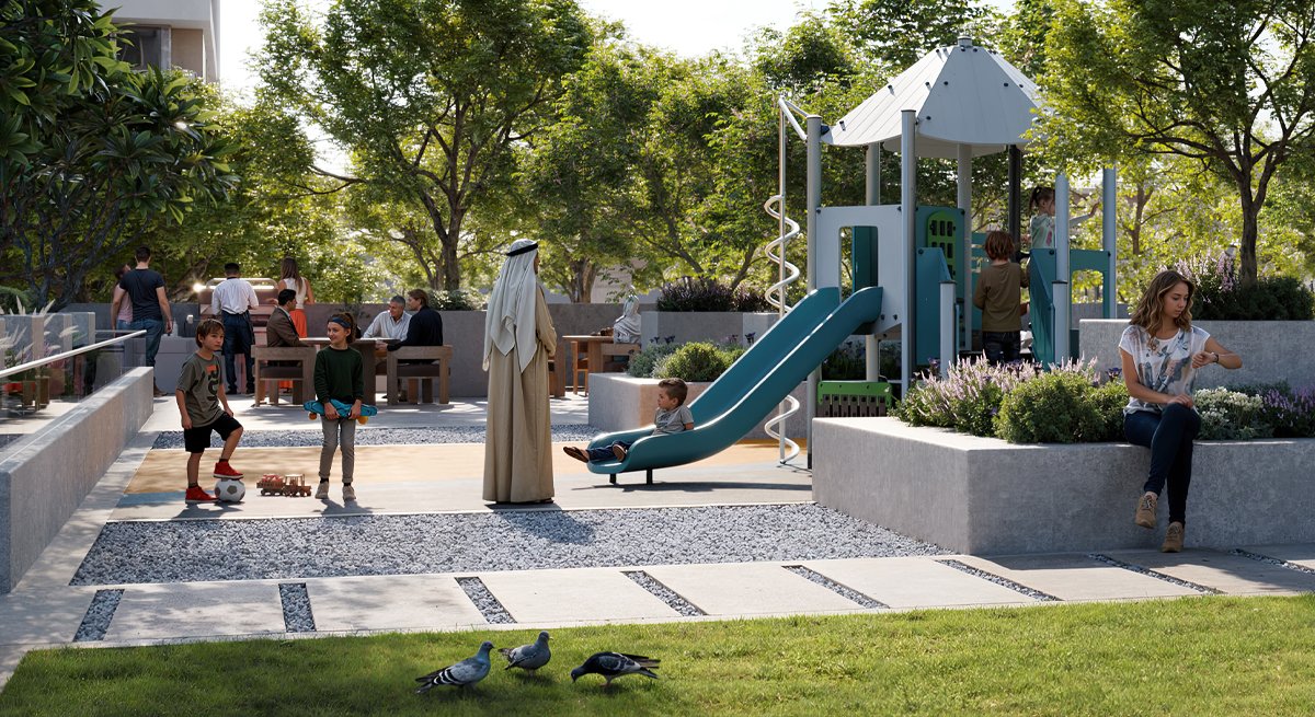 a woman sitting on a bench next to a playground