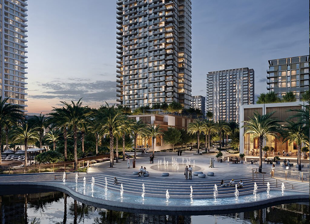 a fountain in the middle of a plaza surrounded by tall buildings